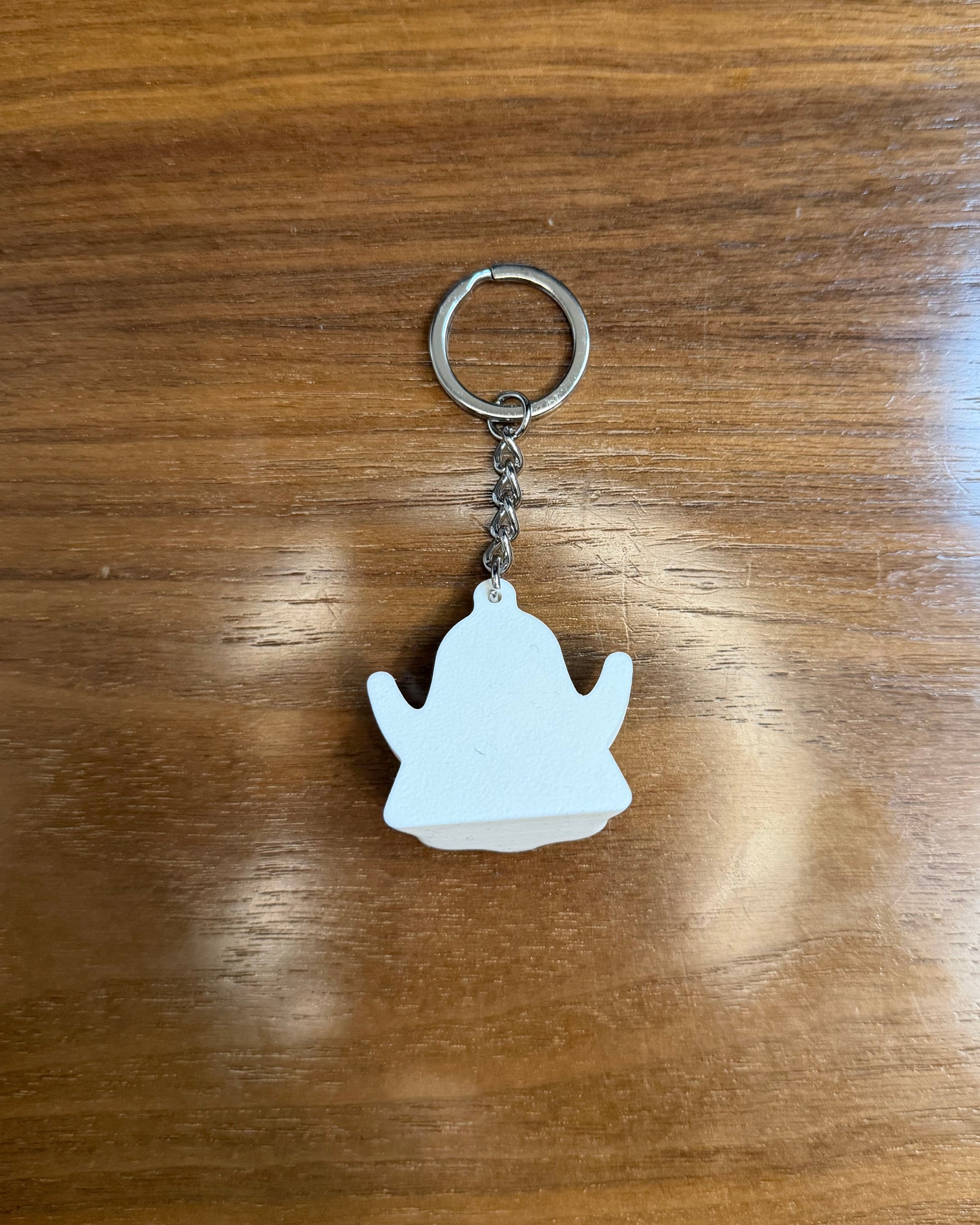 ghost keychain on wood surface