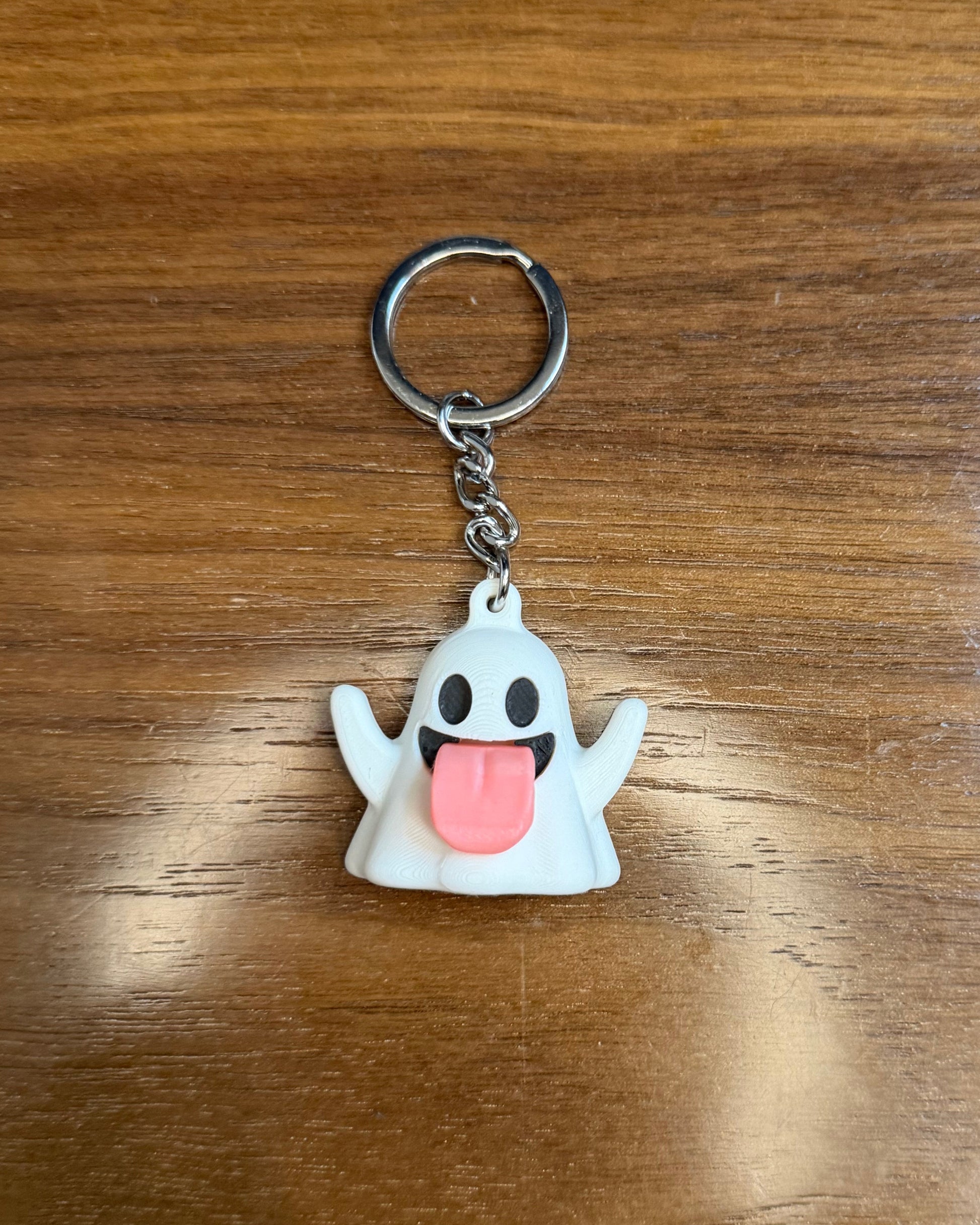 ghost keychain on wood surface